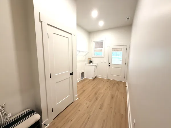 a view of a room with wooden floor and bathroom