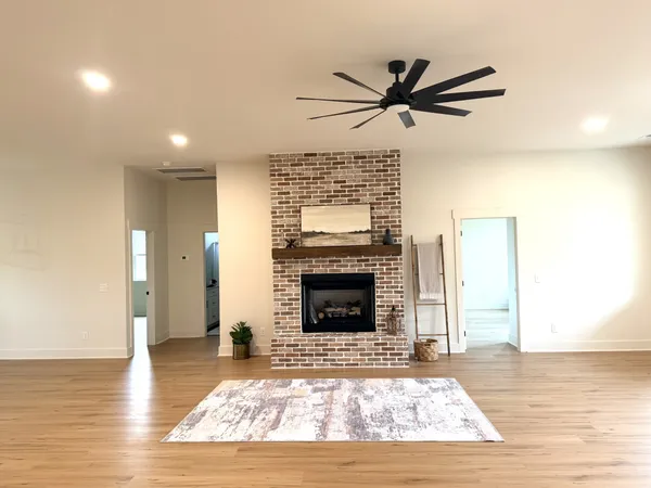 a living room with a fireplace and wooden floor