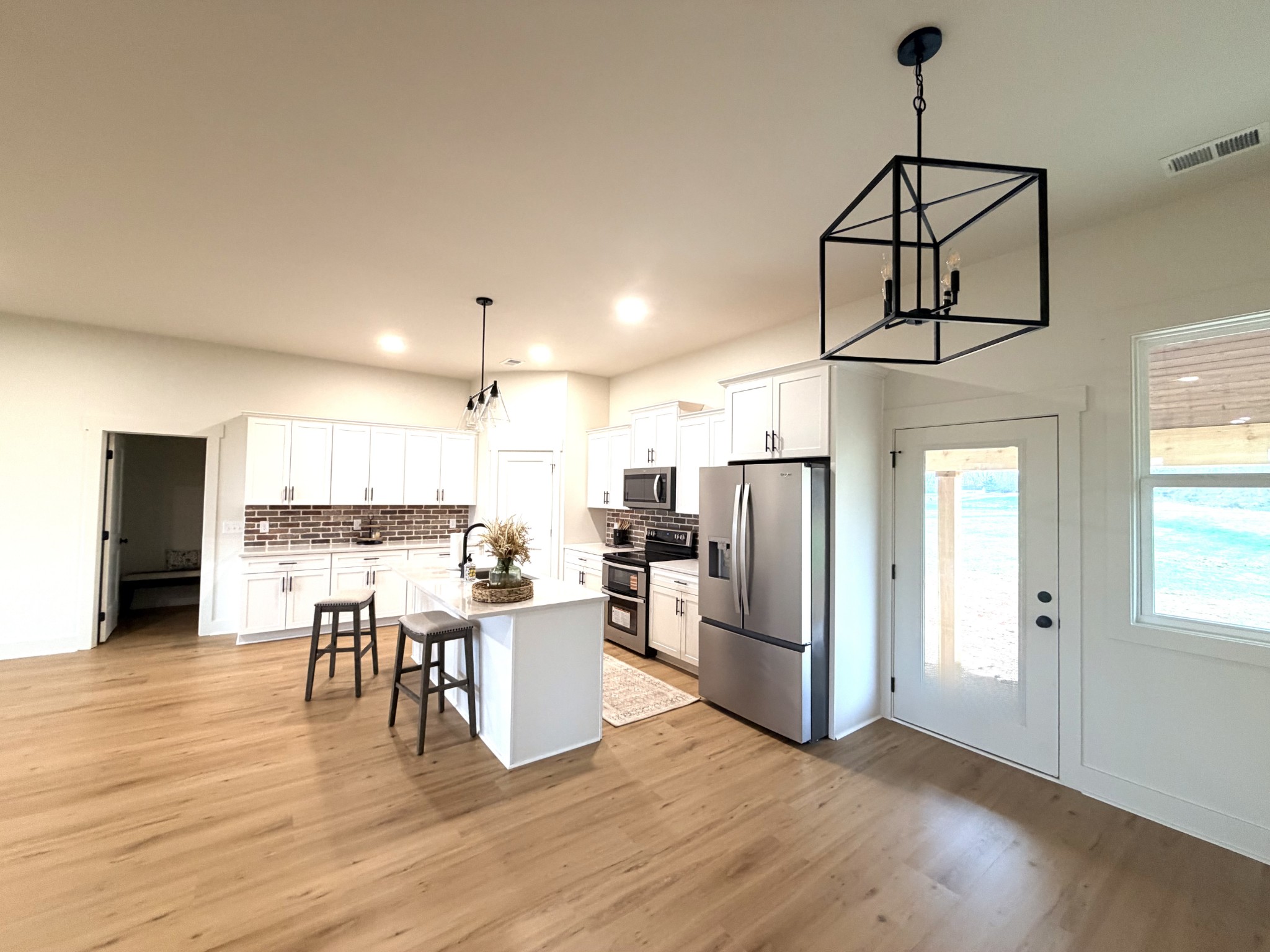 4031 Wells Road Springfield, TN 37172 - Photo 7 of 23 a living room with stainless steel appliances kitchen island granite countertop wooden floor and a view of living room