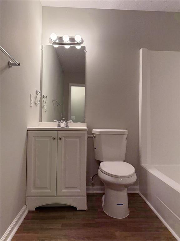 3990 Highway 92 Acworth, GA 30102 - Photo 18 of 26 a bathroom with a toilet a sink and mirror