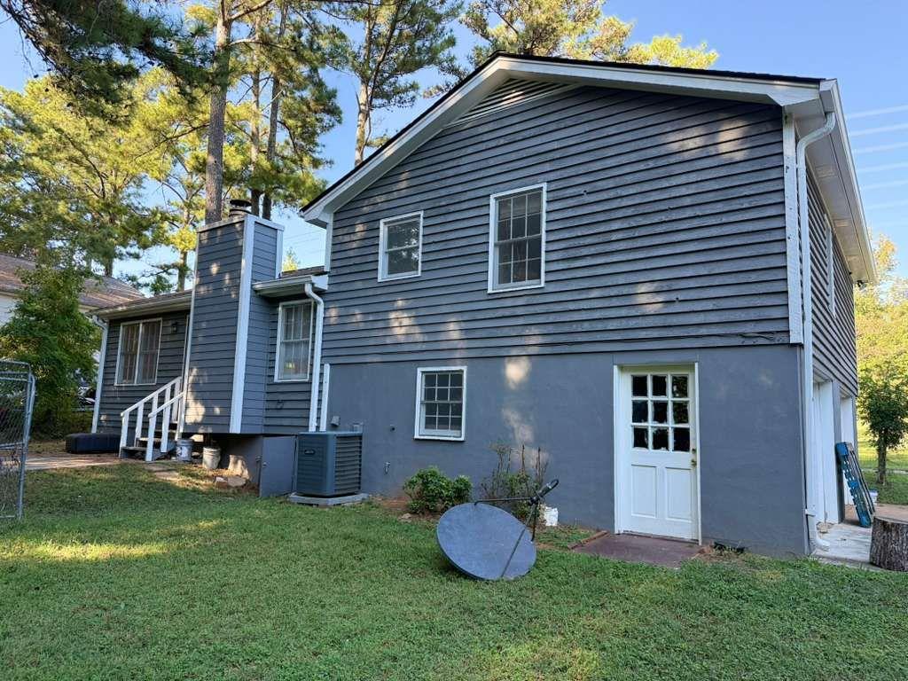 3990 Highway 92 Acworth, GA 30102 - Photo 3 of 26 a front view of a house with a garden and yard
