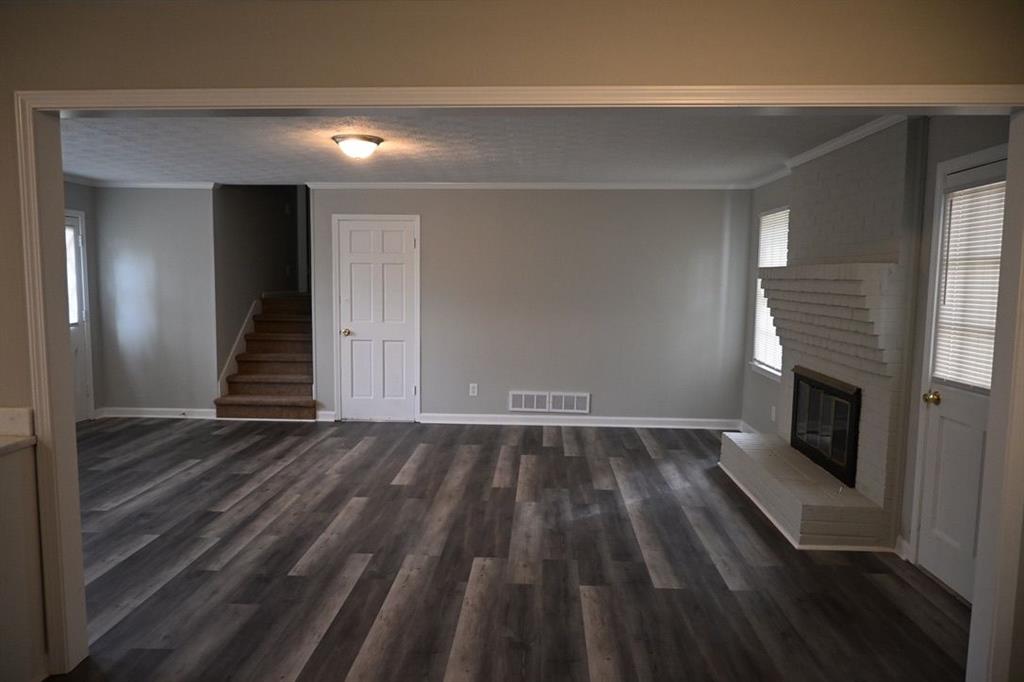 3990 Highway 92 Acworth, GA 30102 - Photo 7 of 26 a view of an empty room with wooden floor and a fireplace