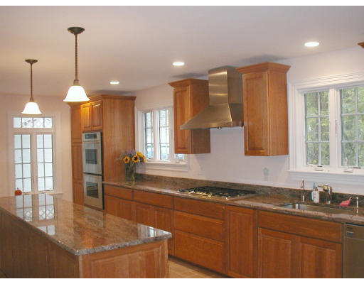 79 Princeton Road Brookline, MA 02467 - Photo 4 of 4 a kitchen with stainless steel appliances granite countertop a sink a stove and a refrigerator