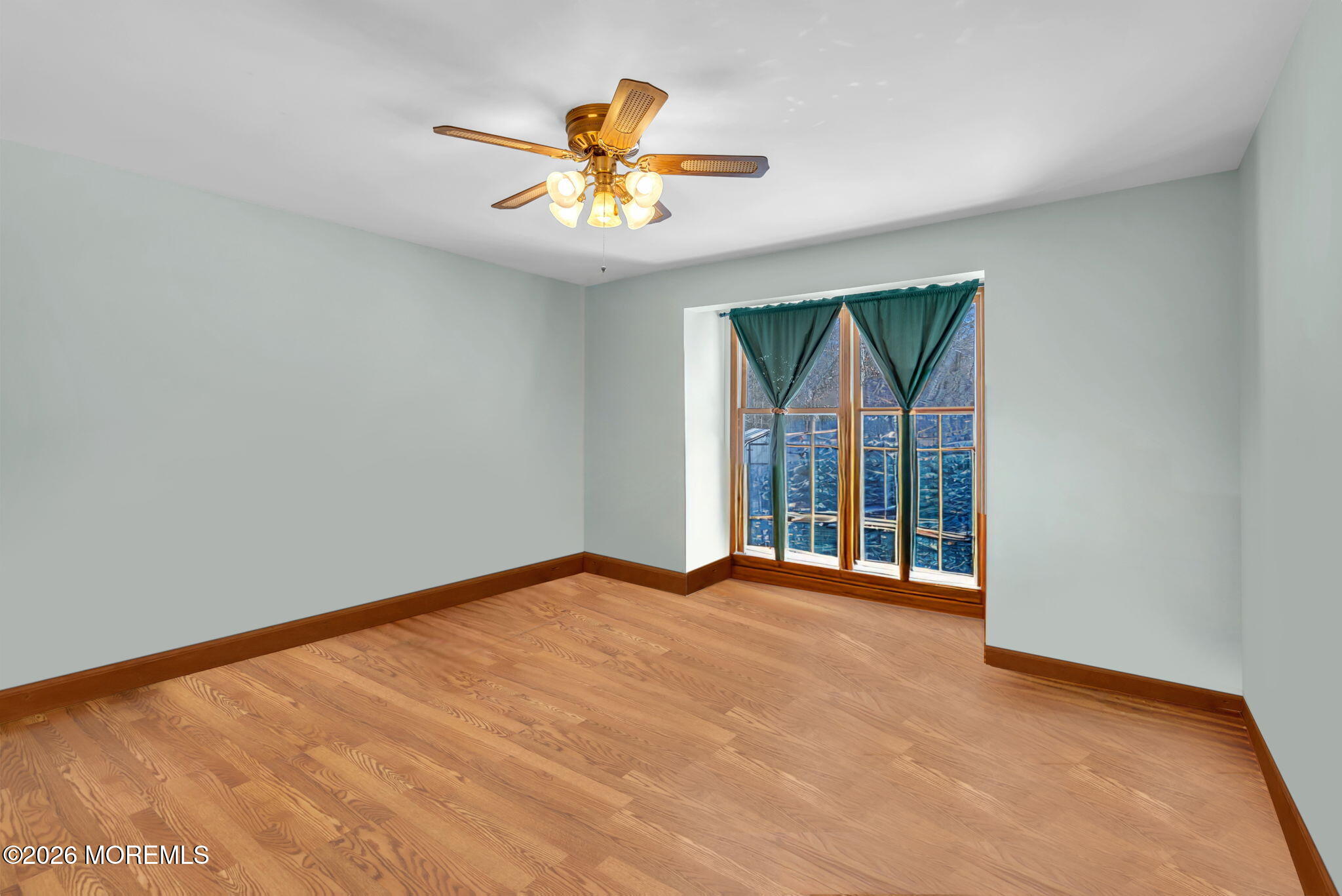 177 Cedar Swamp Road Jackson, NJ 08527 - Photo 11 of 27 an empty room with windows and chandelier fan