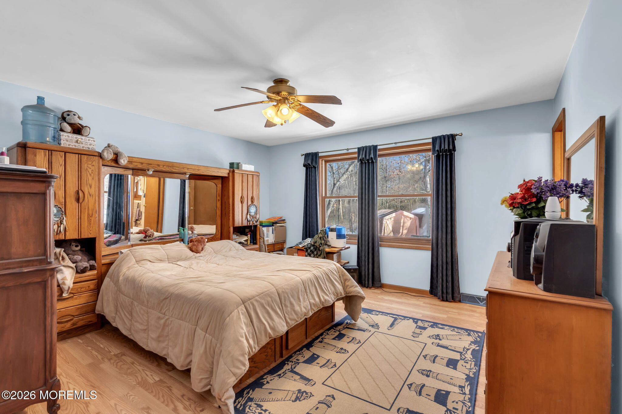 177 Cedar Swamp Road Jackson, NJ 08527 - Photo 18 of 27 a bedroom with a large bed and a chandelier
