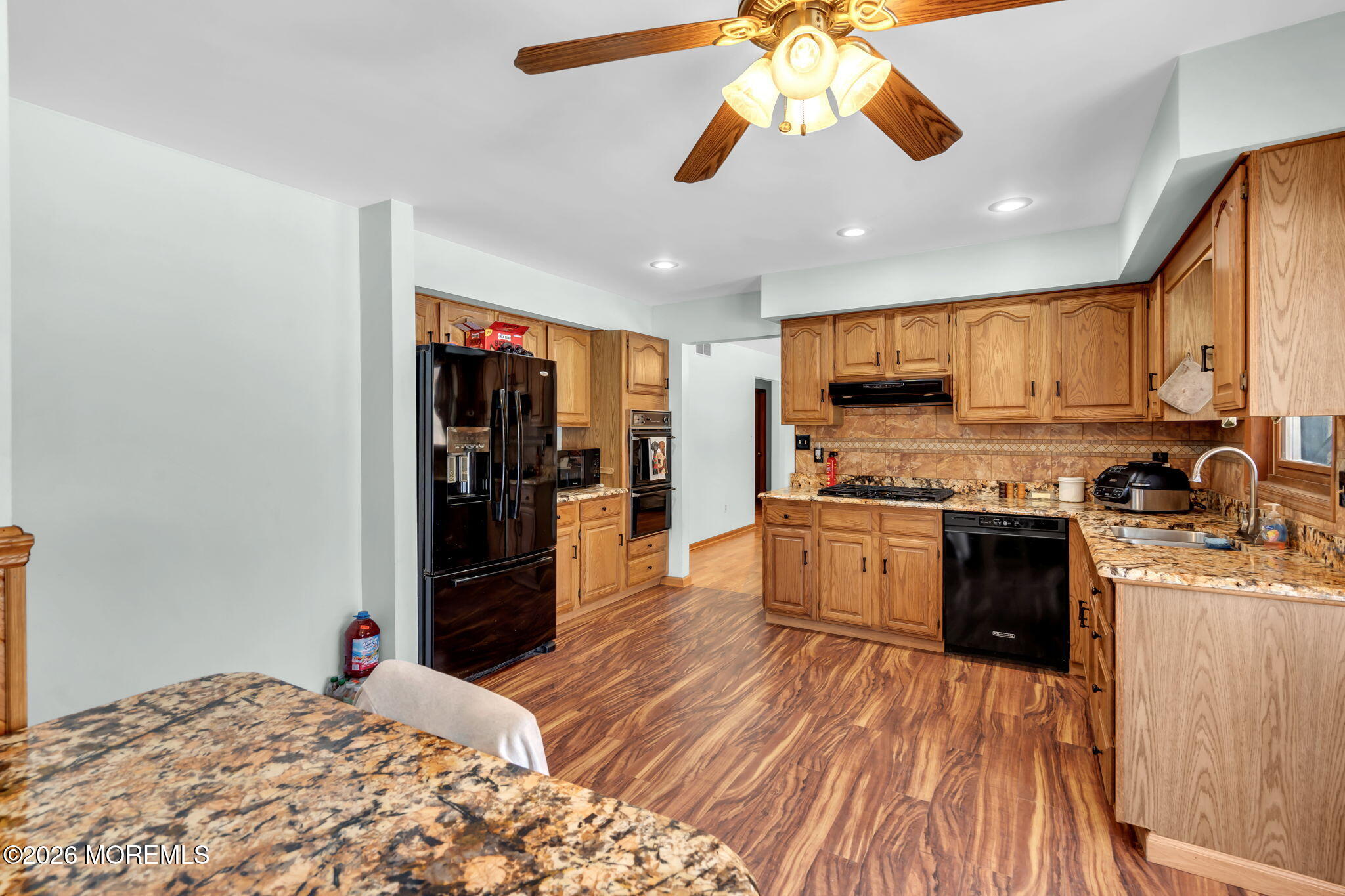 177 Cedar Swamp Road Jackson, NJ 08527 - Photo 5 of 27 a kitchen with stainless steel appliances granite countertop a refrigerator a stove top oven a sink dishwasher and white cabinets with wooden floor
