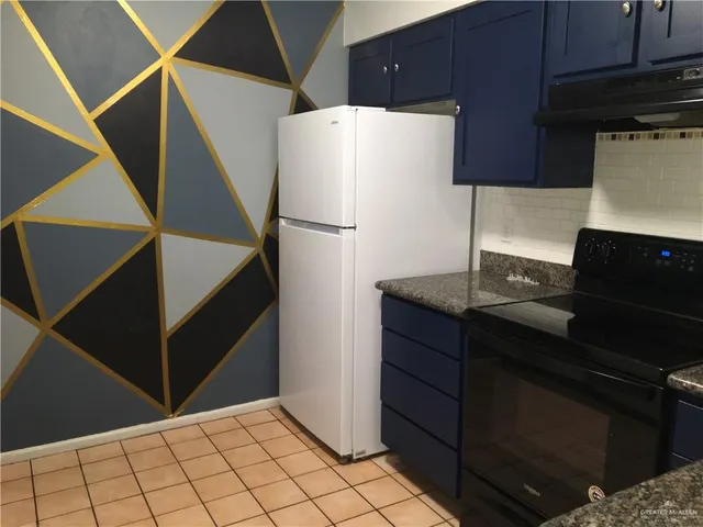 a kitchen with a refrigerator and cabinets