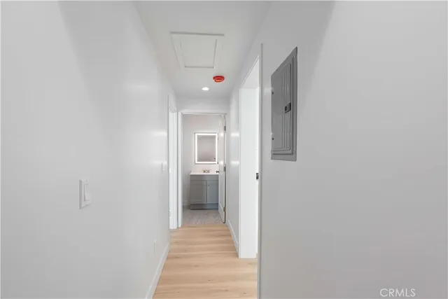 a hallway with stairs and a closet
