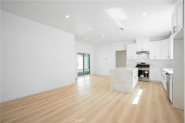 a view of kitchen with cabinets and wooden floor