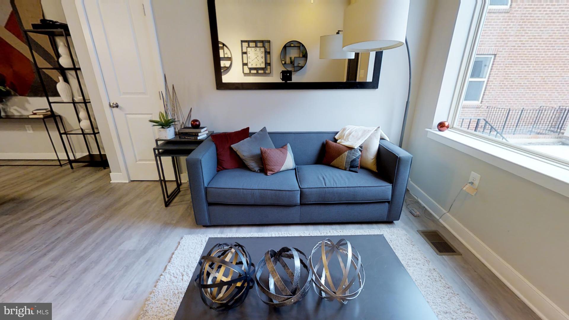1262 Talbert Street Southeast, Unit B Washington, DC 20020 - Photo 1 of 18 a living room with furniture and wooden floor