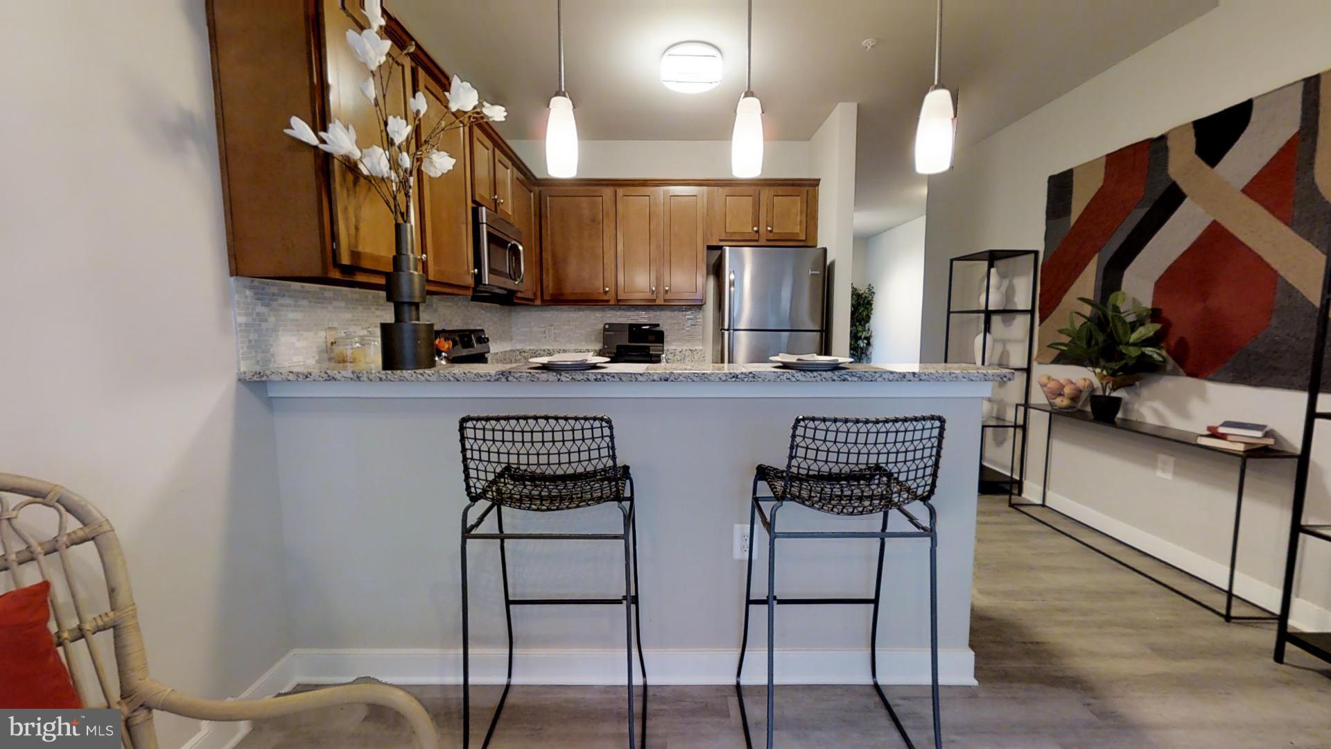 1262 Talbert Street Southeast, Unit B Washington, DC 20020 - Photo 3 of 18 a kitchen with stainless steel appliances granite countertop a sink and a refrigerator