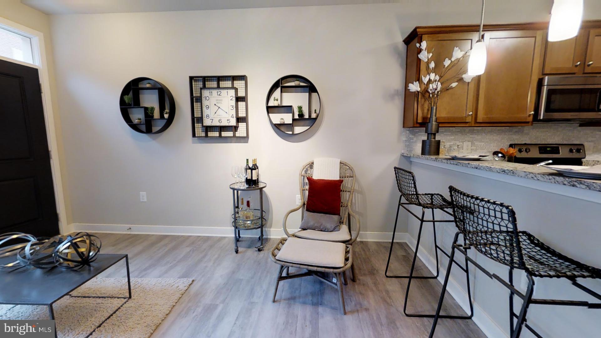1262 Talbert Street Southeast, Unit B Washington, DC 20020 - Photo 4 of 18 a view of a kitchen with dining area and wooden floor