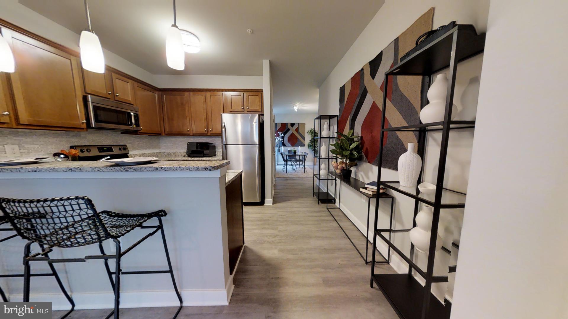 1262 Talbert Street Southeast, Unit B Washington, DC 20020 - Photo 7 of 18 a kitchen with stainless steel appliances granite countertop a refrigerator and a stove top oven