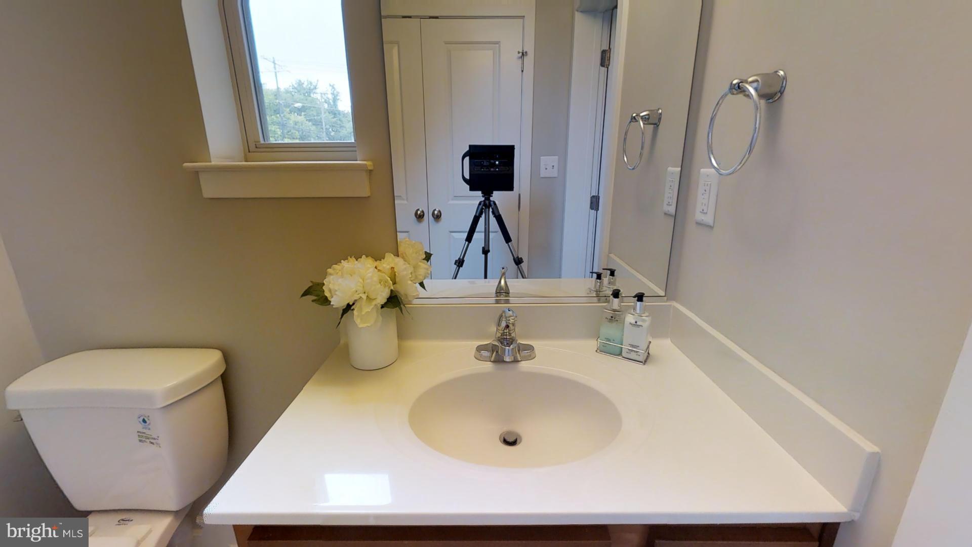 1262 Talbert Street Southeast, Unit B Washington, DC 20020 - Photo 9 of 18 a bathroom with a toilet sink and mirror