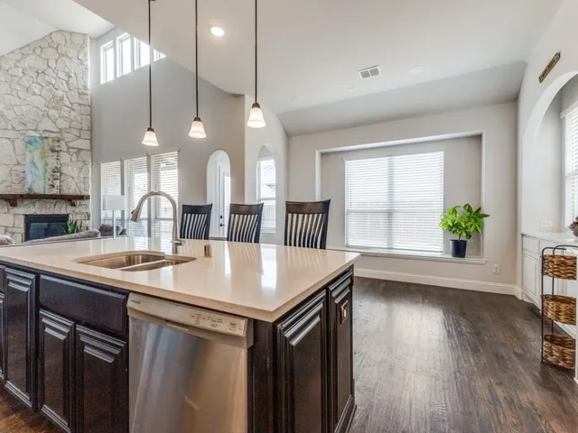a kitchen with a table chairs and a large window