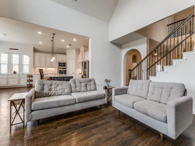 a living room with furniture and a view of kitchen