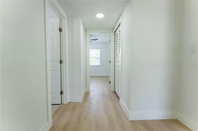 a view of a hallway with wooden floor