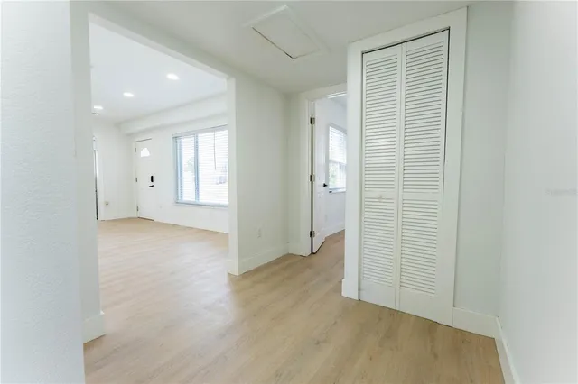 an empty room with windows and closet