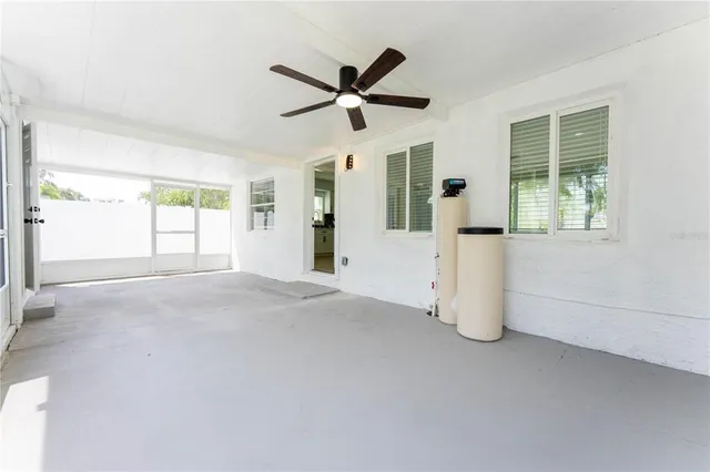 a view of a livingroom with a ceiling fan and windows