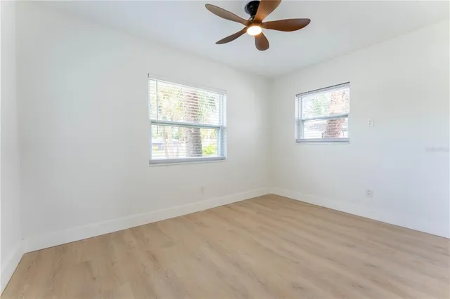 a view of a big room with wooden floor closet and windows