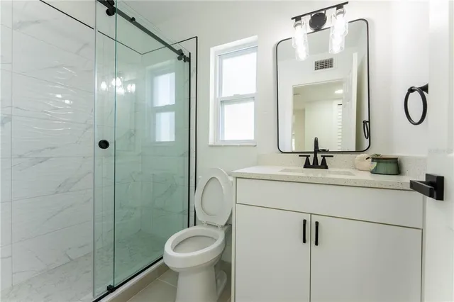 a bathroom with a sink toilet and shower