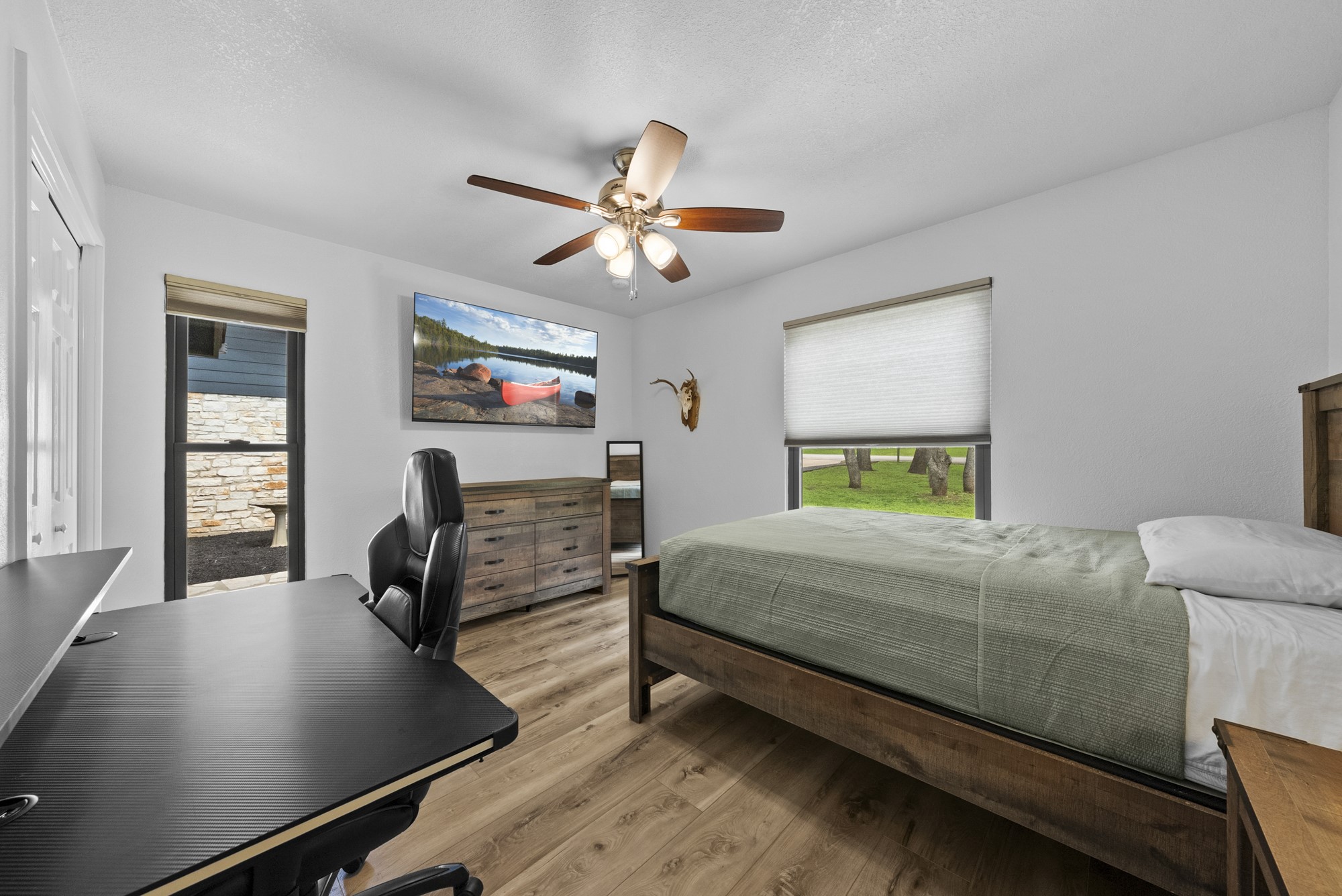 2802 Robin Road Manchaca, TX 78652 - Photo 35 of 40 Bright room featuring wood-finish flooring, white walls, and a ceiling fan with integrated lighting