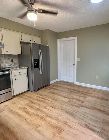 a kitchen with stainless steel appliances a refrigerator and a stove top oven