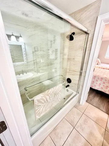 a living room with bed and a wooden floor