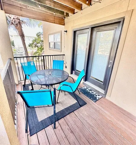 a view of a swimming pool with a patio and fire pit