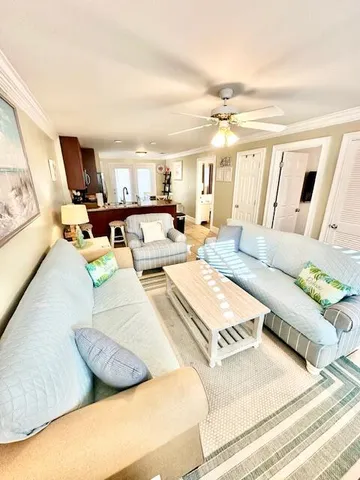 a living room with furniture and a chandelier