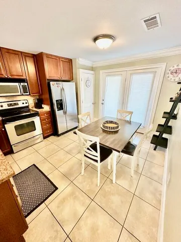 a bedroom with a bed and a view of kitchen