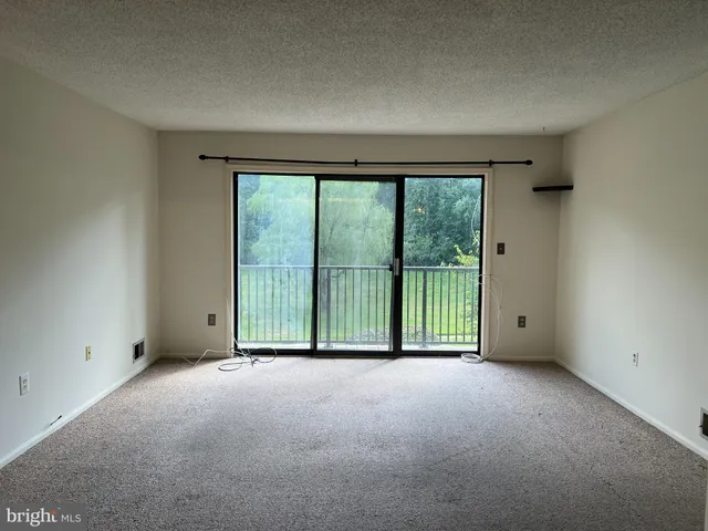 a view of an empty room with a balcony