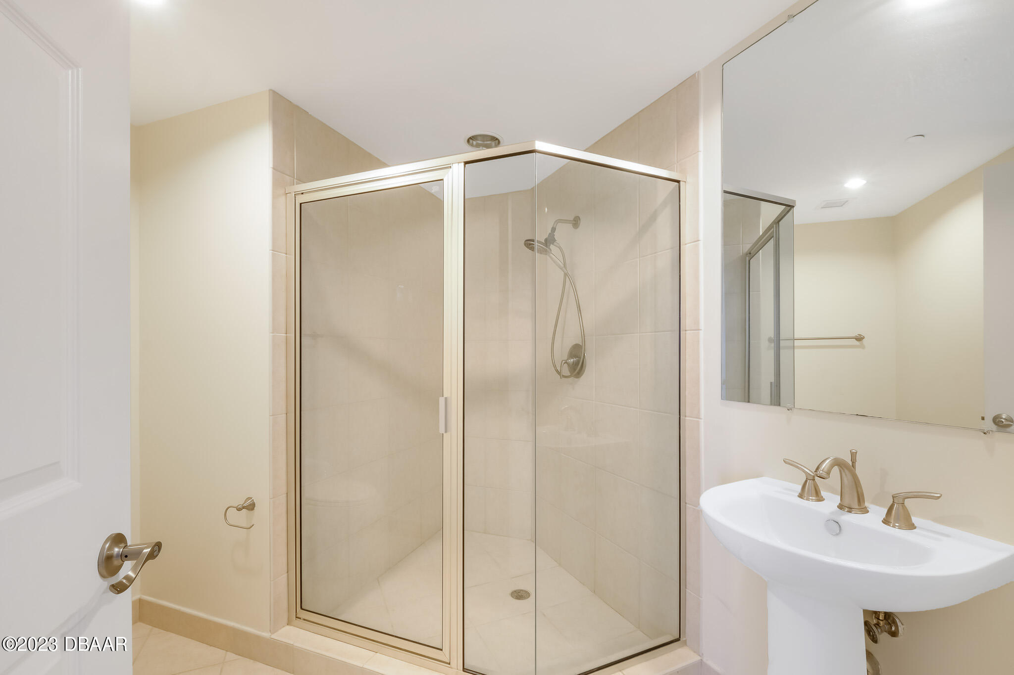 241 Riverside Drive, Unit 1710 Holly Hill, FL 32117 - Photo 31 of 46 a bathroom with a shower sink and mirror