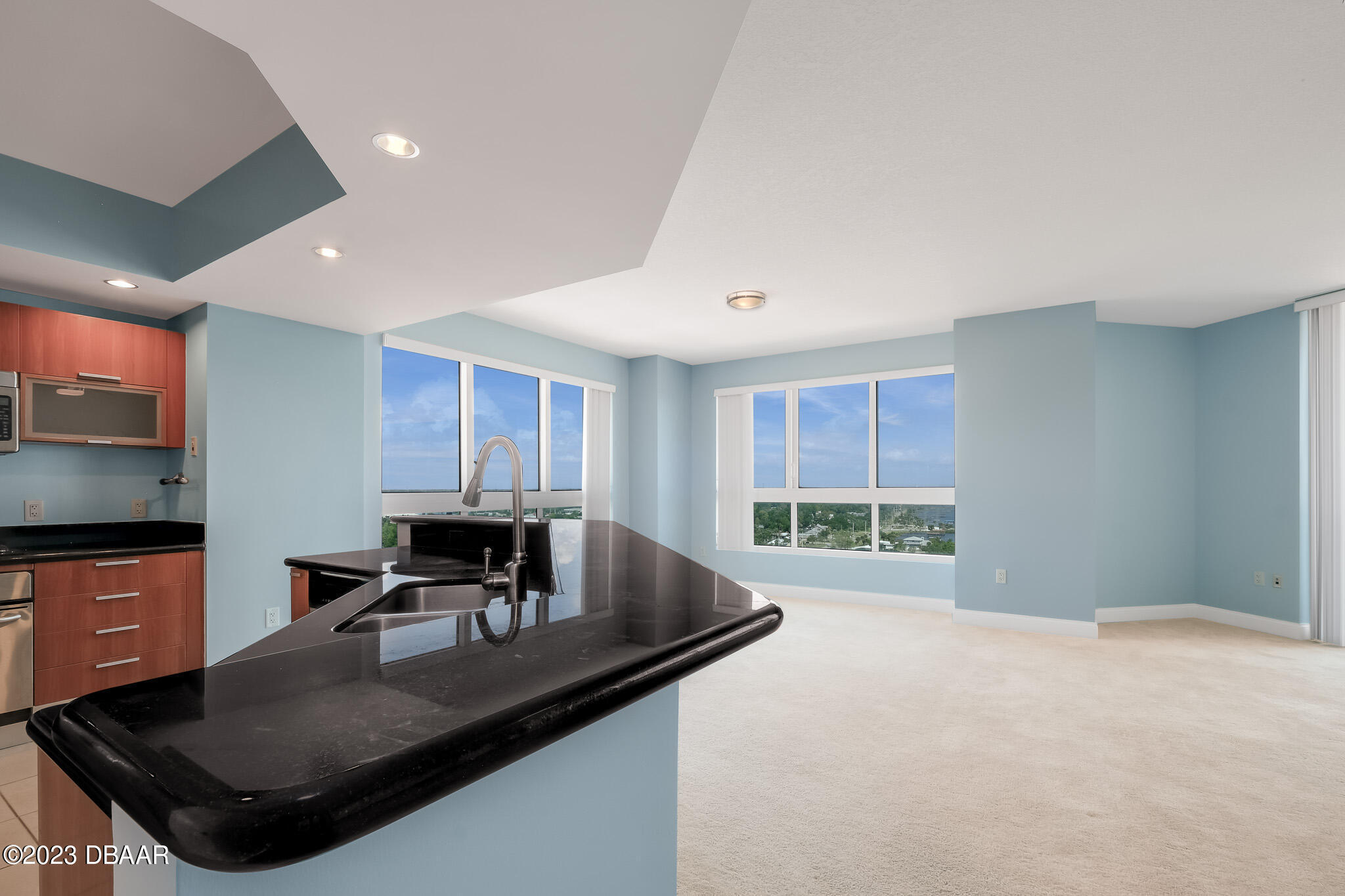 241 Riverside Drive, Unit 1710 Holly Hill, FL 32117 - Photo 6 of 46 a kitchen with stainless steel appliances granite countertop a sink a stove and a refrigerator