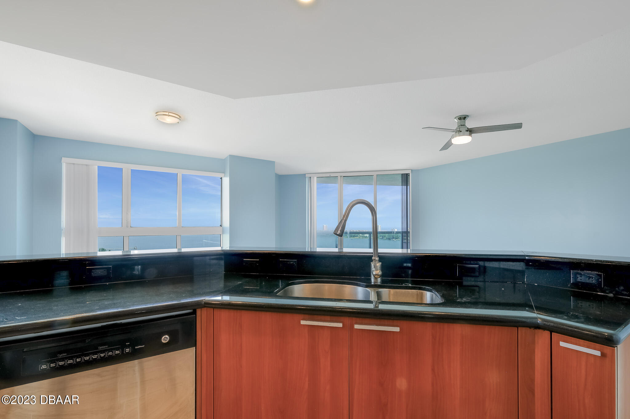 241 Riverside Drive, Unit 1710 Holly Hill, FL 32117 - Photo 8 of 46 a kitchen with granite countertop a sink stainless steel appliances and cabinets