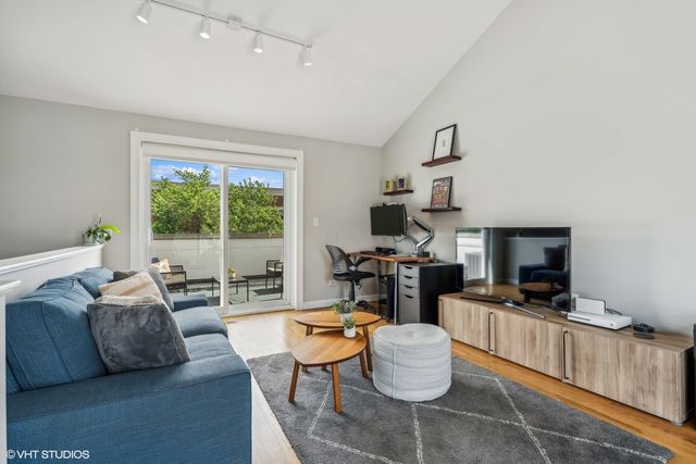 a living room with fireplace furniture and a large window