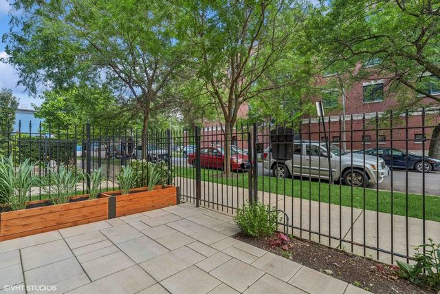 a view of a park with iron fence