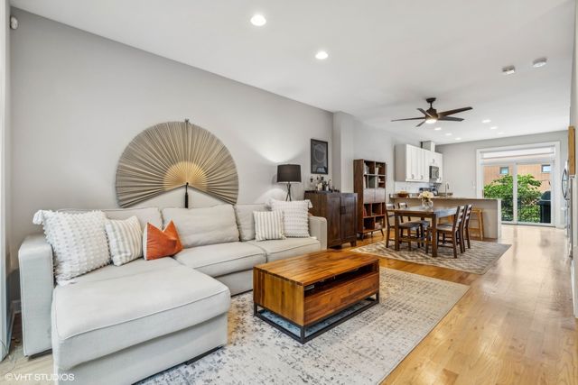 a living room with furniture a chandelier and a rug