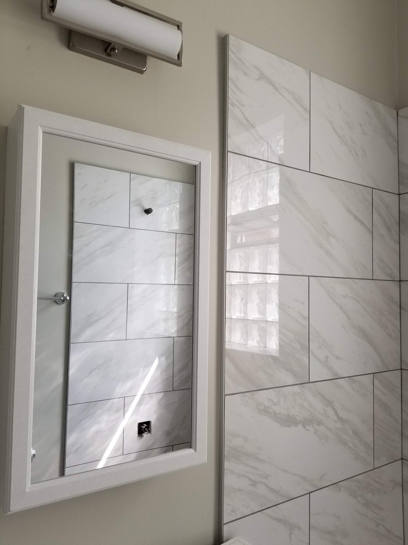 4764 North Virginia Avenue, Unit 112 Chicago, IL 60625 - Photo 10 of 12 a bathroom with a glass shower door