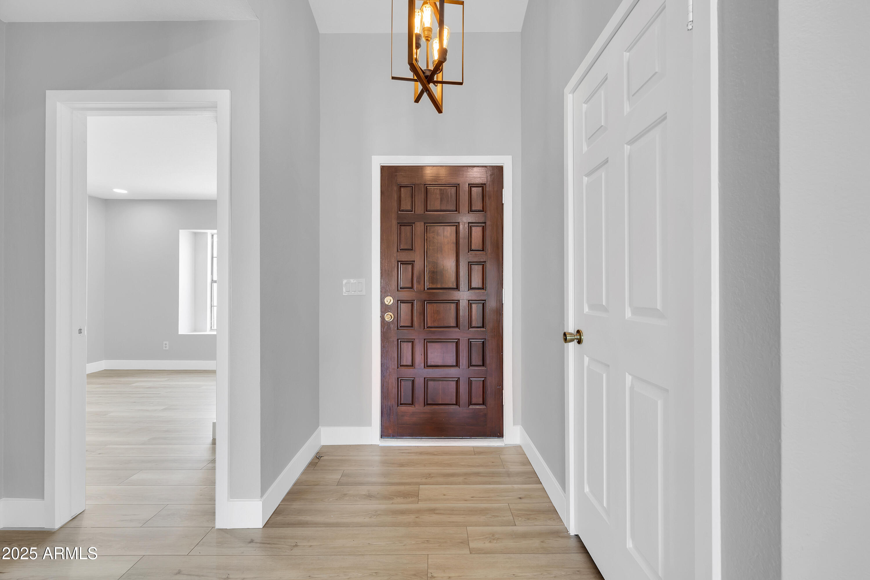 5302 West Cheryl Drive Glendale, AZ 85302 - Photo 11 of 39 a view of a hallway with wooden floor and entryway