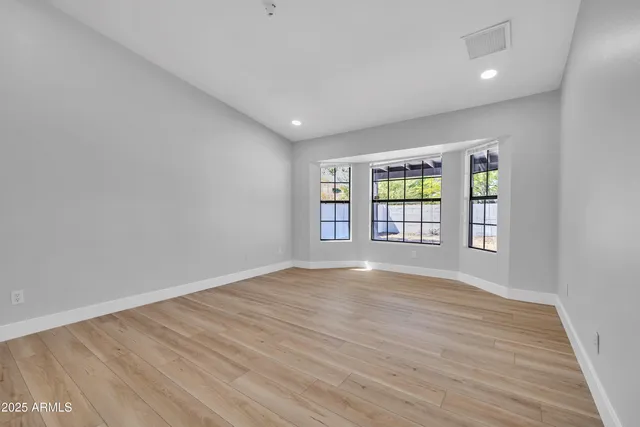 wooden floor in an empty room with a window
