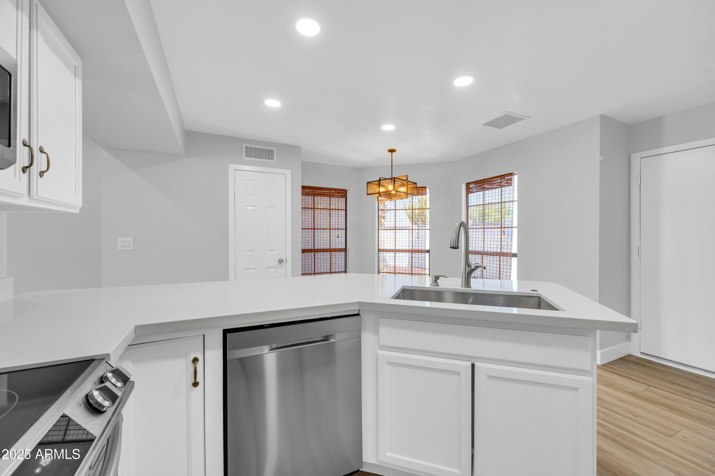 5302 West Cheryl Drive Glendale, AZ 85302 - Photo 16 of 39 a kitchen with stainless steel appliances granite countertop a sink and a hard wood floor