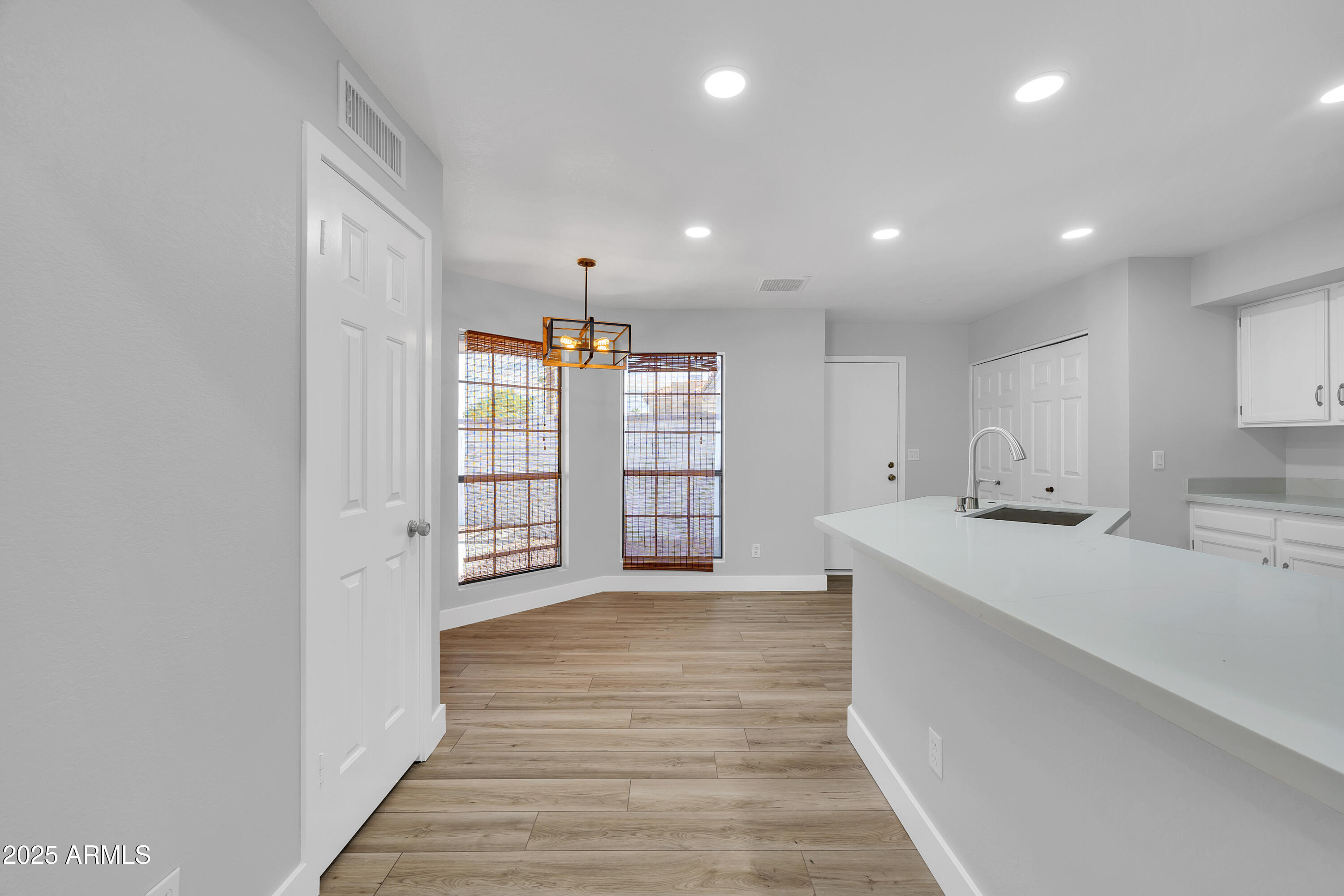 5302 West Cheryl Drive Glendale, AZ 85302 - Photo 20 of 39 a view of an empty room with wooden floor and a window