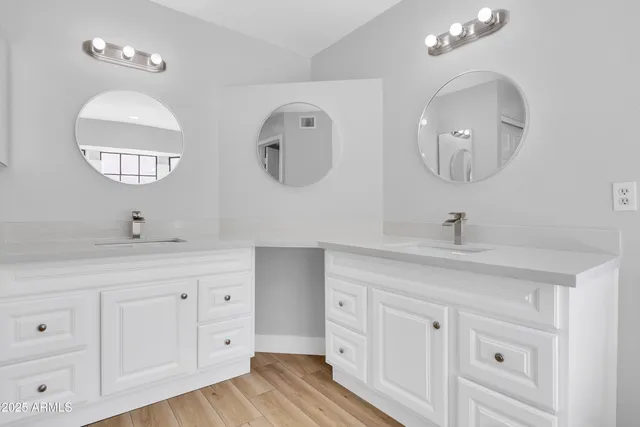 a bathroom with a double vanity sink and a mirror