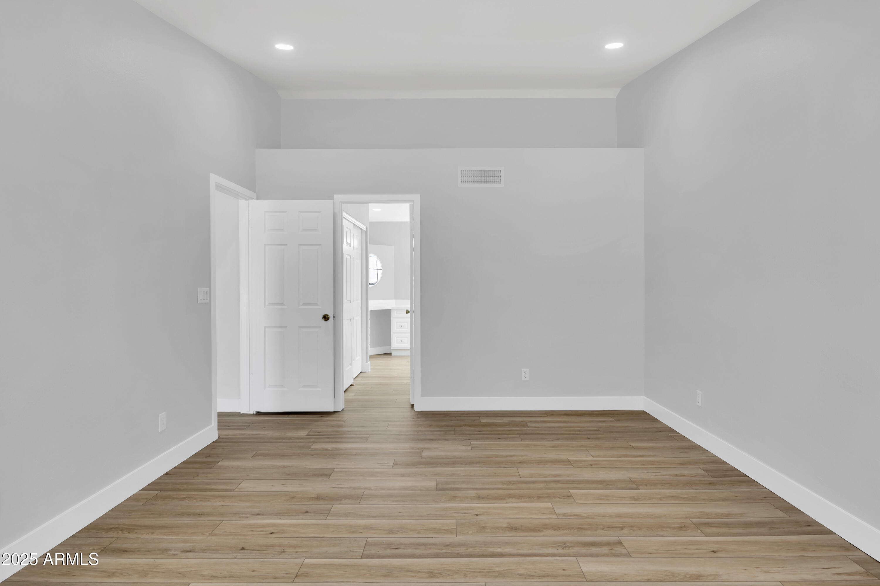 5302 West Cheryl Drive Glendale, AZ 85302 - Photo 26 of 39 a view of an empty room with wooden floor
