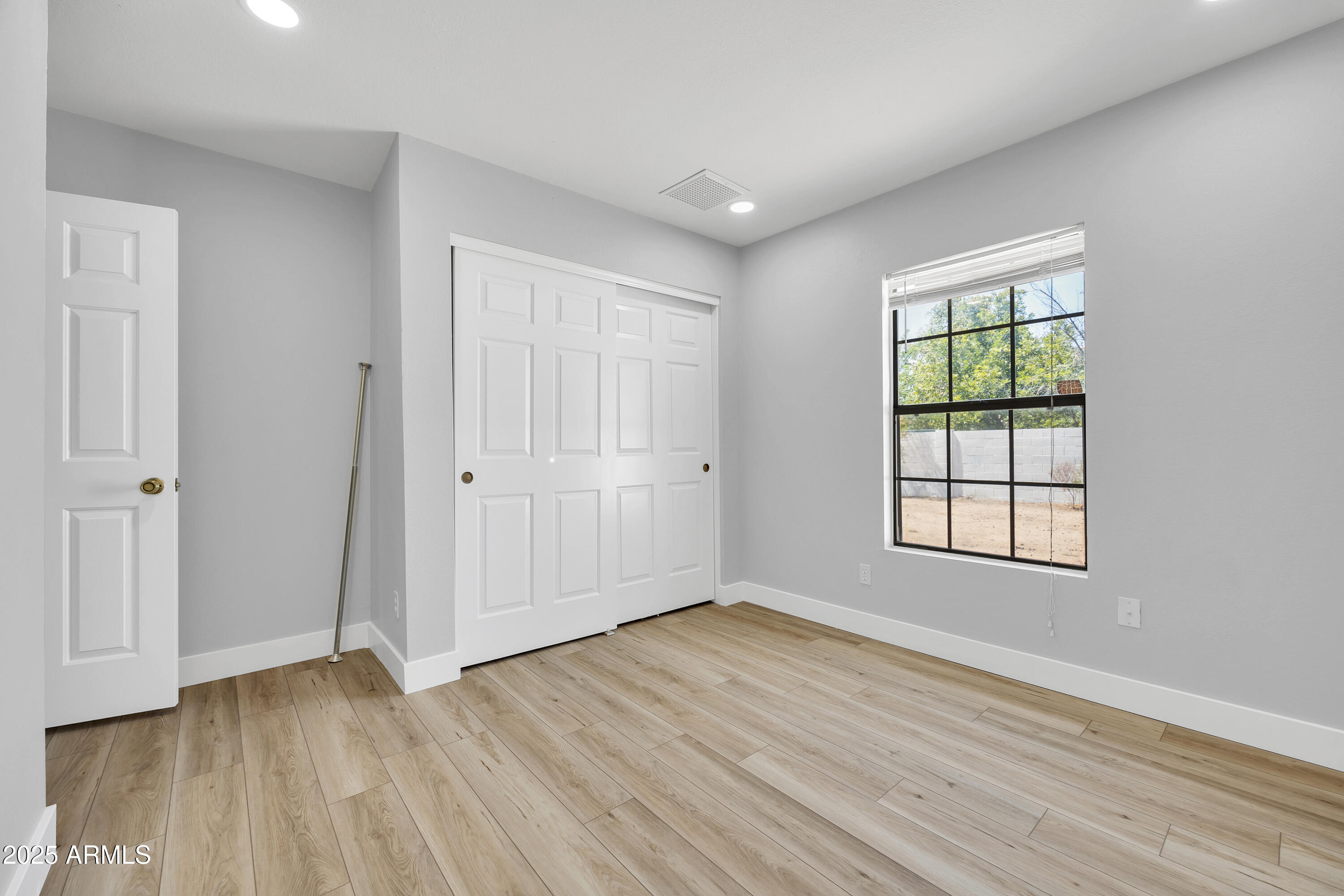 5302 West Cheryl Drive Glendale, AZ 85302 - Photo 28 of 39 a view of a room with wooden floor and window in it