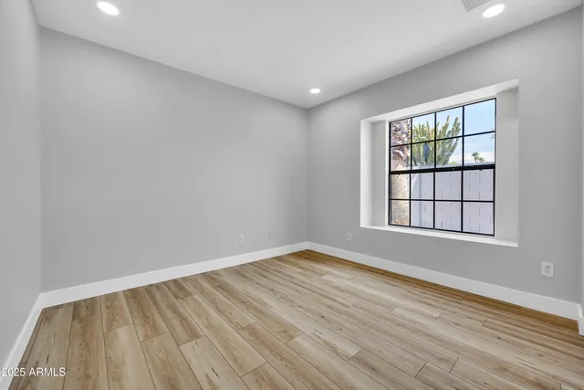 wooden floor in an empty room with a window
