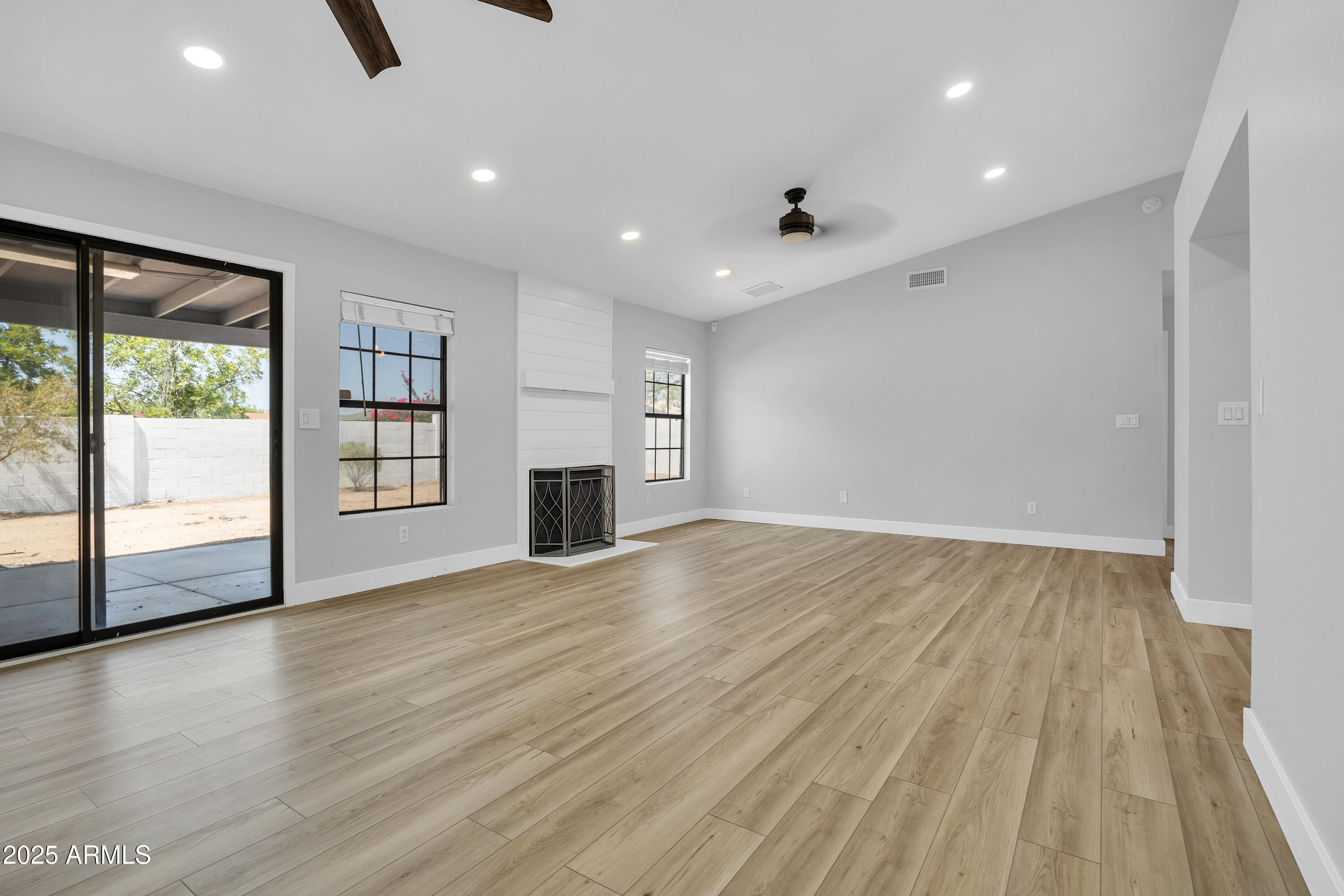 5302 West Cheryl Drive Glendale, AZ 85302 - Photo 8 of 39 an empty room with wooden floor and windows