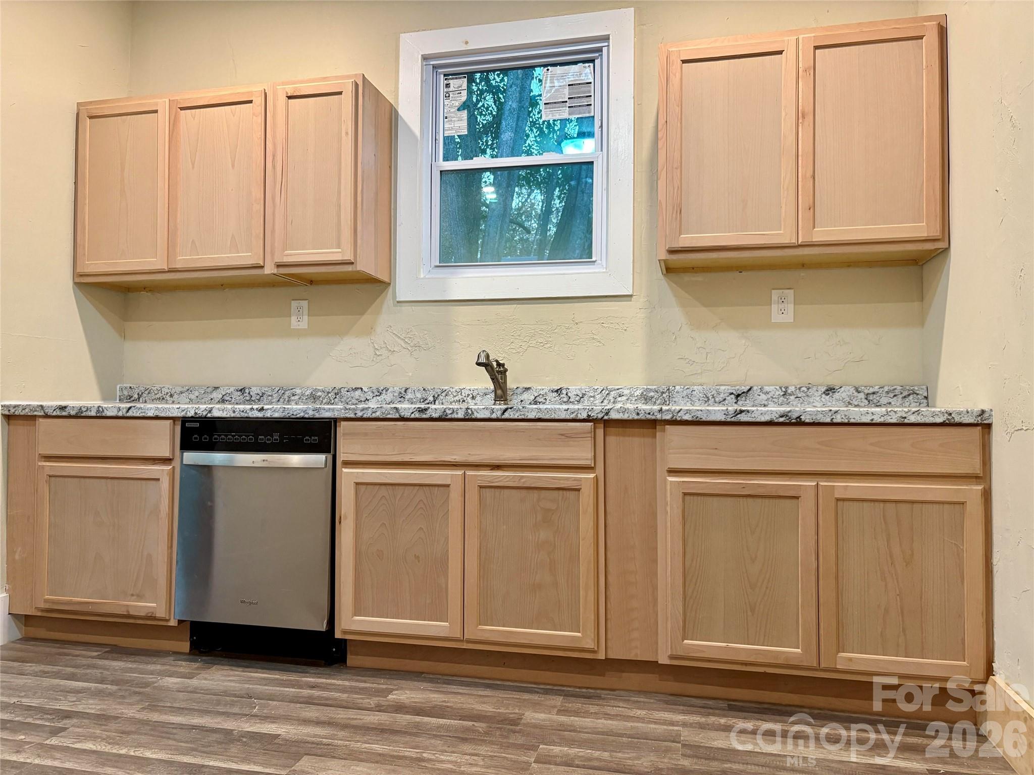 427 East Orr Street Anderson, SC 29621 - Photo 12 of 24 a white kitchen with granite countertop stainless steel appliances white cabinets and a granite counter tops