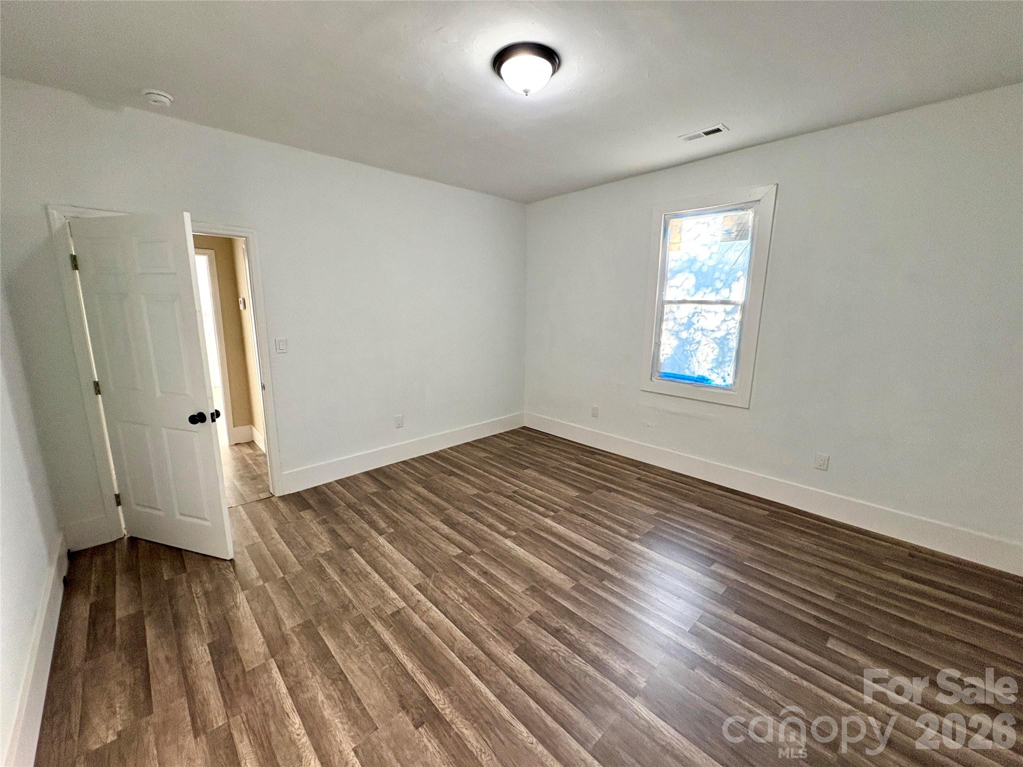 427 East Orr Street Anderson, SC 29621 - Photo 22 of 24 an empty room with wooden floor and windows